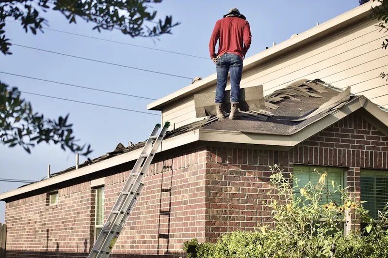 Professional roofer working on a residential roof in Mason Woods